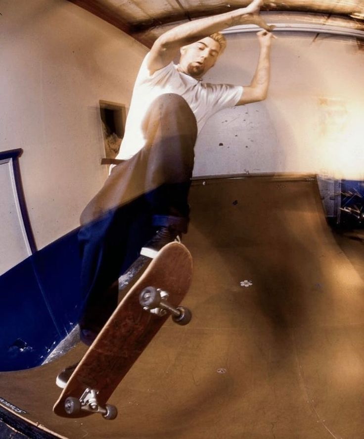 a man riding a skateboard up the side of a ramp