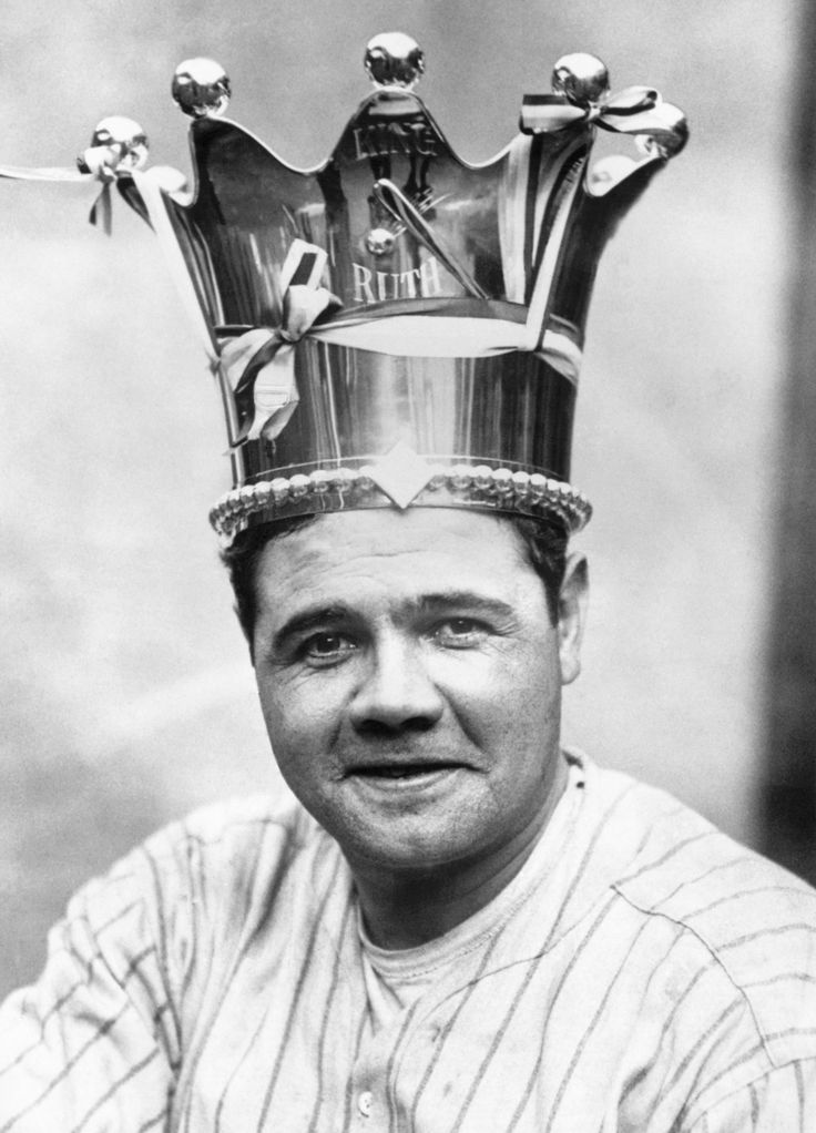 a black and white photo of a man with a crown on top of his head