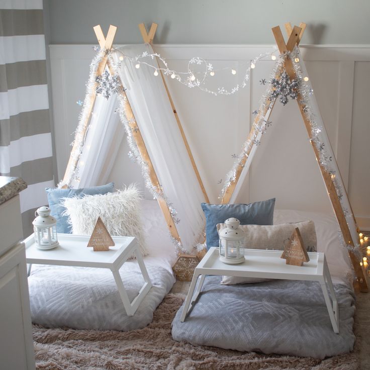 two teepees with lights on them in a bedroom