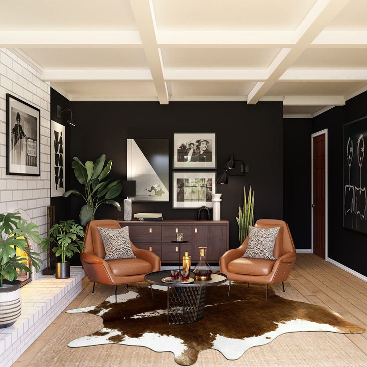 a living room with two chairs and a coffee table in front of a black wall