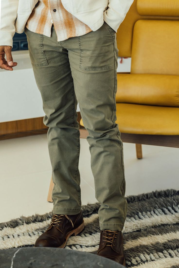 Introducing our Fatigue Pants, a modern interpretation of the vintage OG-107 military fatigue pants. Inspired by the demanding tasks of "Fatigue Duty" assigned to soldiers during non-combat activities, these pants combine functionality with contemporary style. Crafted with a modern straight cut, they offer a more slim and fitted silhouette compared to their vintage counterparts. Made from a stretch twill Oxford fabric that has undergone garment/pigment dyeing, these pants exude a vintage broken- Military Olive Cargo Pants With Side Pockets, Olive Military Cargo Pants With Side Pockets, Olive Military Cargo Pants With Multiple Pockets, Relaxed Fit Combat Pants In Khaki, Relaxed Fit Khaki Combat Pants, Cotton Combat Pants With Straight Leg, Combat Style Cotton Straight Leg Pants, Cotton Combat Straight Leg Pants, Olive Utility Cargo Jeans