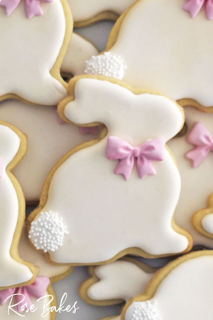 decorated cookies in the shape of bunnies with pink bows and bow ties on them