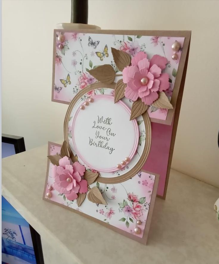 a card with flowers on it sitting on a table