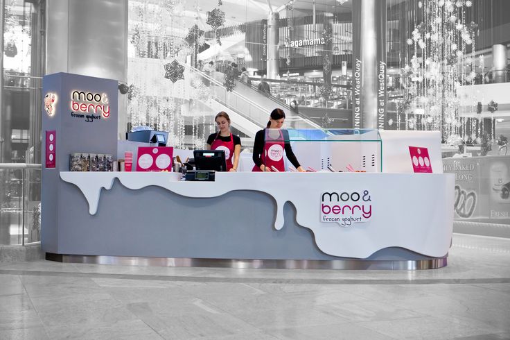 two people standing behind a counter in an office building with the words boom yonnee written on it