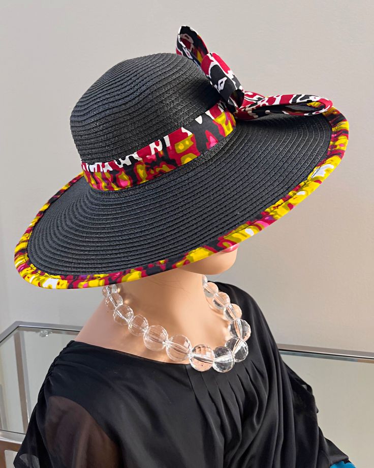 ombines timeless elegance with vibrant cultural flair. Handcrafted with care, this hat features a beautifully woven straw base adorned with bold African print fabric, offering both style and sun protection. Perfect for church services, outdoor events, or simply adding a touch of sophistication to your outfit, this hat blends tradition with modern design. Lightweight and breathable, it's as comfortable as it is striking. Elevate your look with a hat that celebrates heritage and craftsmanship. One size: should fit all. Multicolor Sun Hat For Beach And Kentucky Derby, Multicolor Sun Hat For Kentucky Derby Vacation, Summer Black Handwoven Sun Hat, Multicolor Sun Hat For Vacation And Kentucky Derby, Multicolor Straw Panama Hat With Curved Brim, Black Handwoven Straw Hat With Curved Brim, Multicolor Sun Hat For Vacation At Kentucky Derby, Black Handwoven Hat With Curved Brim, Summer Black Handwoven Hats