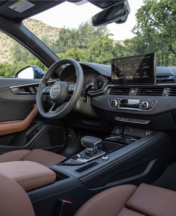 the interior of a car with dashboard, steering wheel and dash board showing various electronic devices