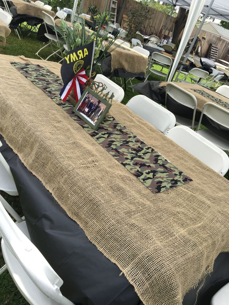 the table is set up for an army themed party with pictures and decorations on it