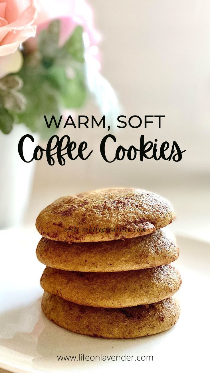 soft cinnamon coffee cookies stacked on top of each other with pink flowers in the background