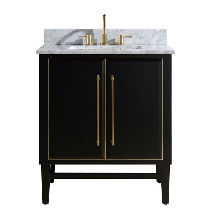 a bathroom vanity with a marble top and two gold faucets on the sink