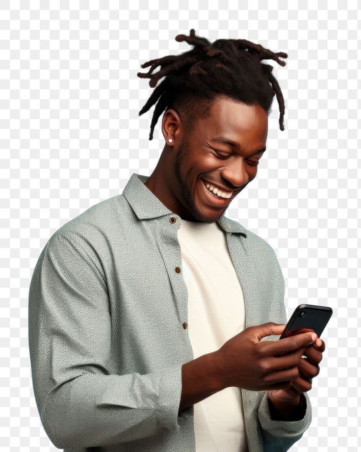 a man with dreadlocks is looking at his cell phone while smiling and laughing