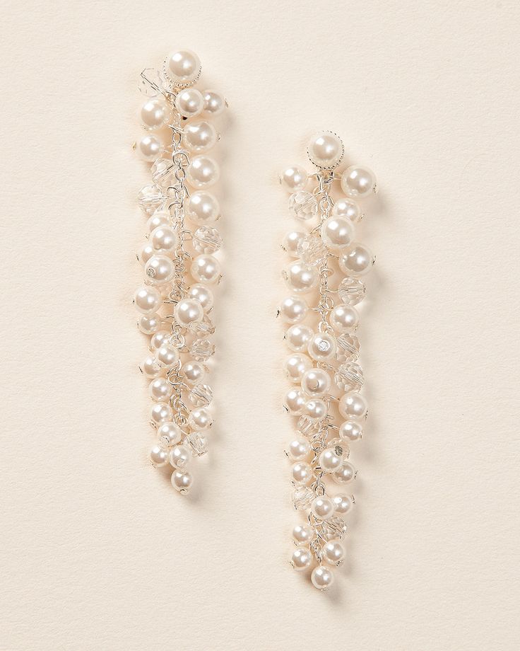 Fabulous & fun for any outfit, you'll love our Cascading Pearl & Crystal Earrings. Made with ivory pearls and crystal beads that dangle beautifully to frame the face. Details: Made with light ivory pearls and crystals along a silver chain. Specifications: 3" in length x 0.5" wide. Extremely lightweight. Easily worn all day and evening. Tarnish Resistant: Earring metals are tarnish resistant for long lasting shine. Hypoallergenic: Earrings are hypoallergenic, lead-free & nickel-free. Style #4479 Pearl Charm Dangle Chandelier Earrings, Pearl Dangle Chandelier Earrings With Pearl Charm, Dangle Chandelier Earrings With Pearl Charm, Pearl White Dangle Chandelier Earrings With Pearl Drop, Pearl Chandelier Earrings With Dangling Beads, Wedding Crystal Earrings With Dangling Beads, Elegant Wedding Crystal Earrings With Dangling Beads, Pearl Dangle Beaded Earrings For Party, Pearl Beaded Dangle Earrings For Party