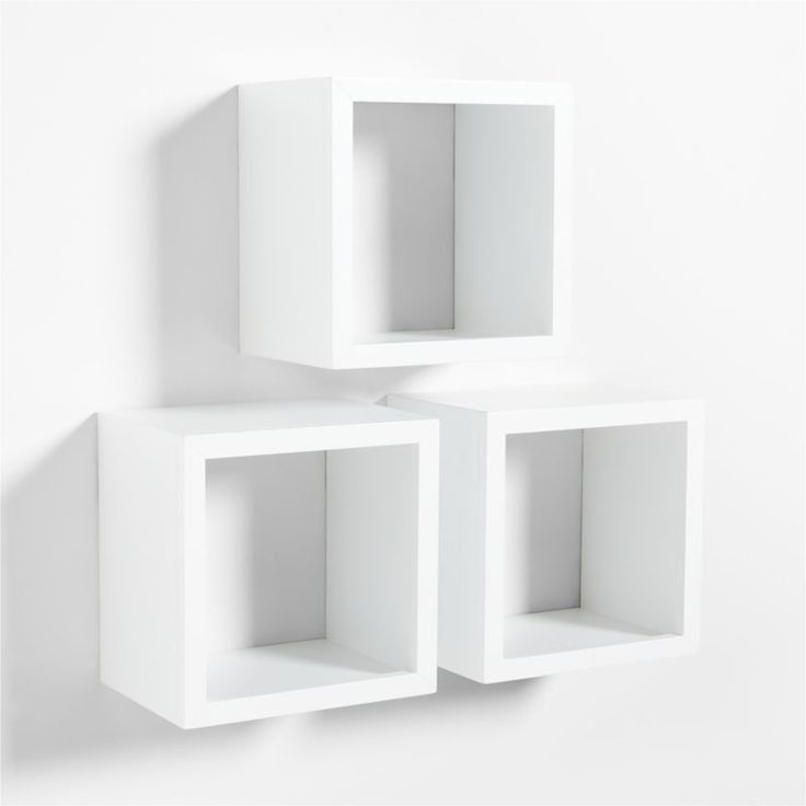 three white cubes are stacked on each other in the shape of bookshelves