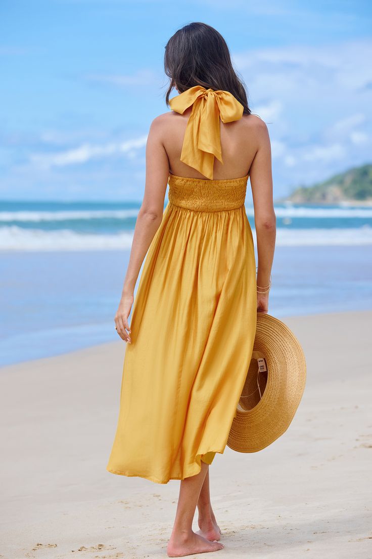 The Sunflower Yellow Halterneck Midi Dress radiates summertime charm with its vibrant hue and flattering design, making it the perfect choice for sunny days and outdoor events. Product code: CAA05A4C139NN Features:  Woven Halter neckline Sleeveless Midi Wash Method: Regular Wash Material: 80%RAYON,20%POLYESTER. Summer Halter Neck Maxi Dress For Brunch, Halter Neck Maxi Dress For Summer Brunch, Breezy Sundress For Summer Garden Party, Beach Halter Neck Dress With Tie Back, Breezy Maxi Dress For Summer Garden Party, Beach Vacation Dresses With Tie Back, Spring Beach Sundress Halter Dress, Spring Halter Sundress For Beach Party, Spring Summer Halter Neck Beach Dress