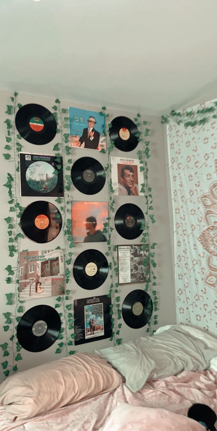 a bedroom with many records on the wall