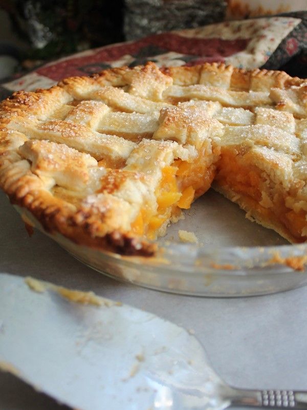 a pie sitting on top of a table next to a fork