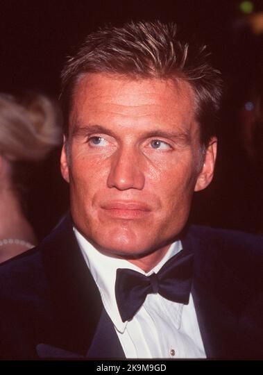 a man in a tuxedo and bow tie looking at the camera with an intense look on his face