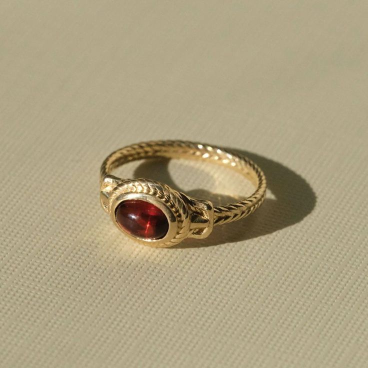 Ancient Heirloom Ring - Garnet – COMMON ERA Elegant Gold Garnet Cabochon Jewelry, Yellow Gold Ring With Historical Design, Gold Garnet Rings With Cabochon, Heirloom 14k Gold Cabochon Ruby Ring, Heirloom 14k Gold Ruby Ring With Cabochon, Ceremonial Oval Cabochon Rings, Traditional Oval Jewelry With Historical Design, Classic 14k Gold Jewelry With Historical Design, Traditional Yellow Gold Cabochon Rings