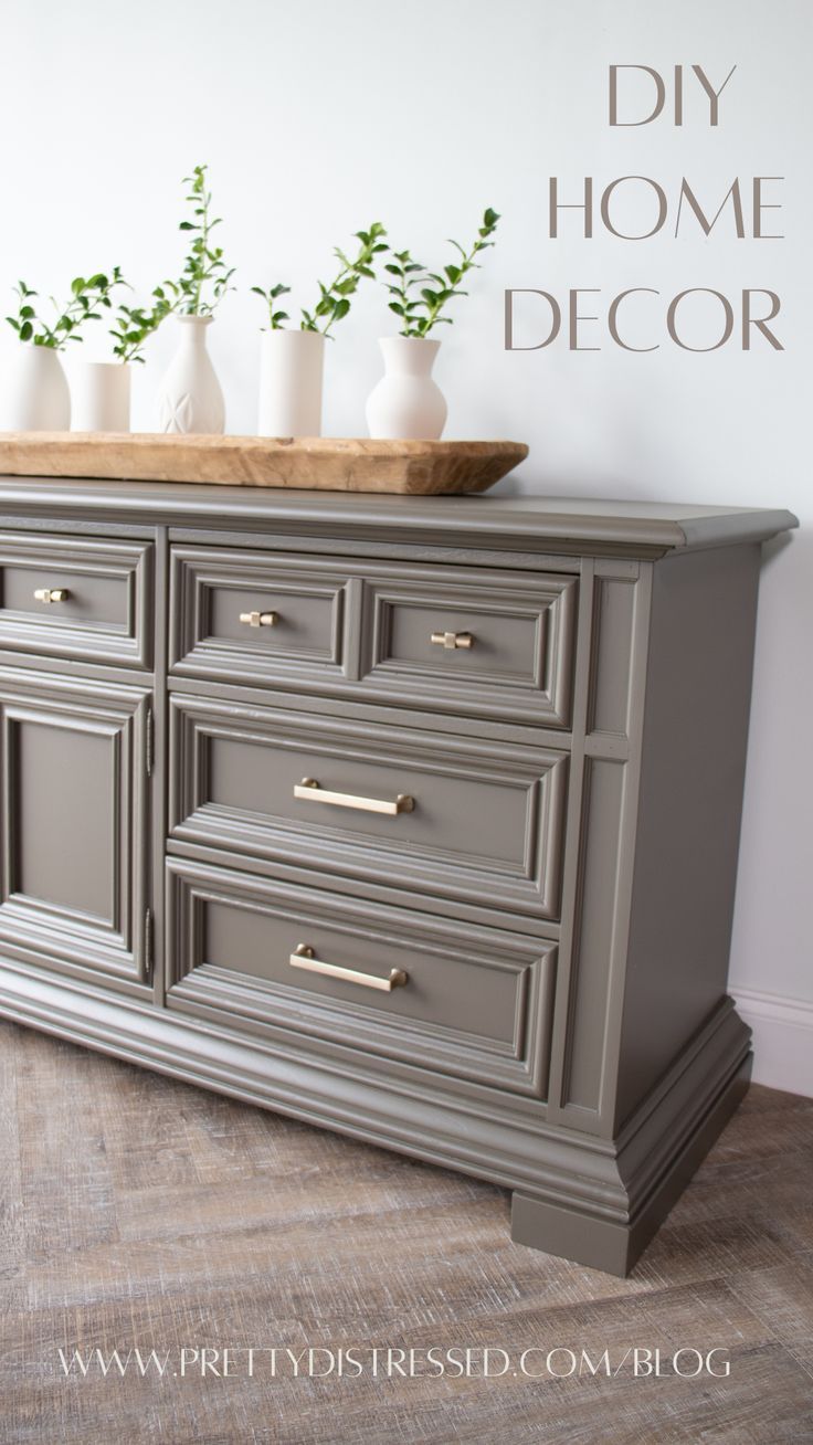 a gray dresser with white vases and greenery on top that says diy home decor