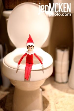 an elf is sitting on the toilet seat