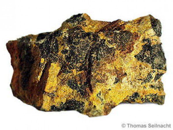 a rock that is yellow and brown with black spots