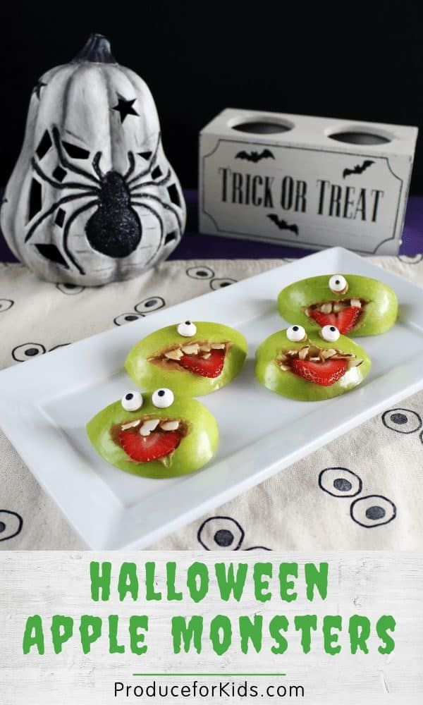 some green apples with googly eyes on them and a trick or treat box in the background