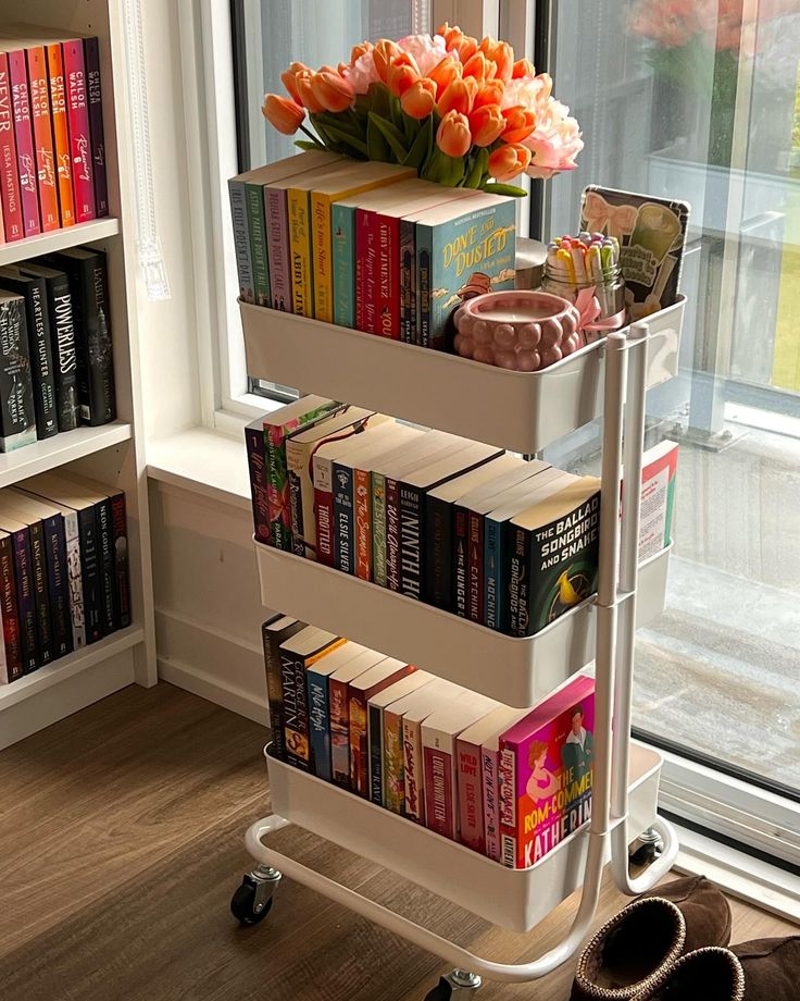 a three tiered book cart with books on it