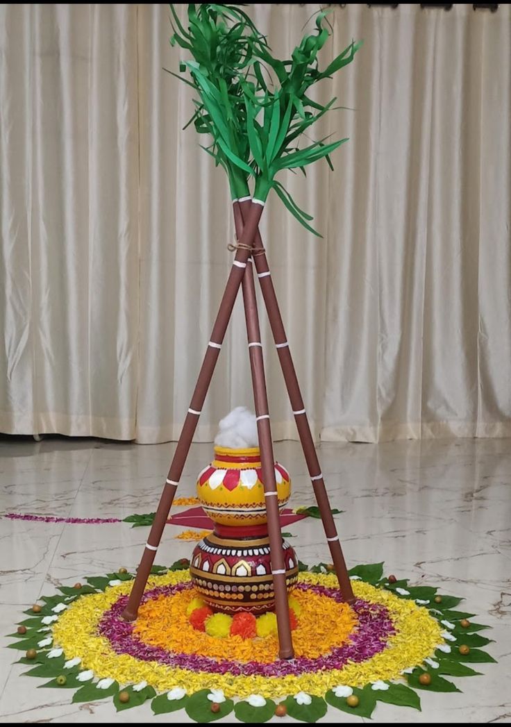 there is a decorative decoration made out of flowers and leaves on the floor in front of a curtain