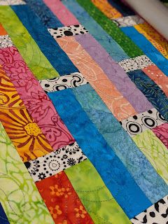 a close up of a colorful quilt on a table