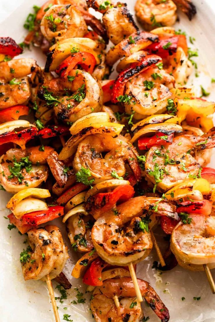 grilled shrimp and vegetable skewers on a white plate