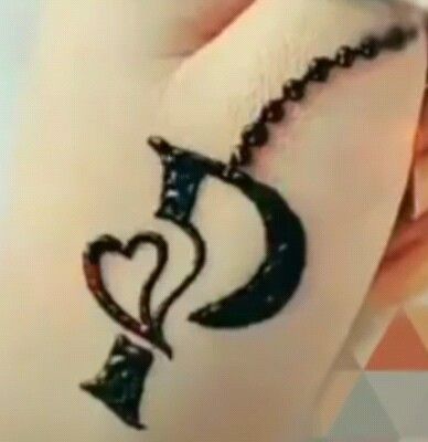 a woman's hand with a tattoo on her left arm and the word love written in