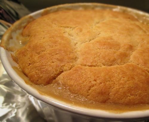 a close up of a pie in a pan with some sauce on the top and bottom