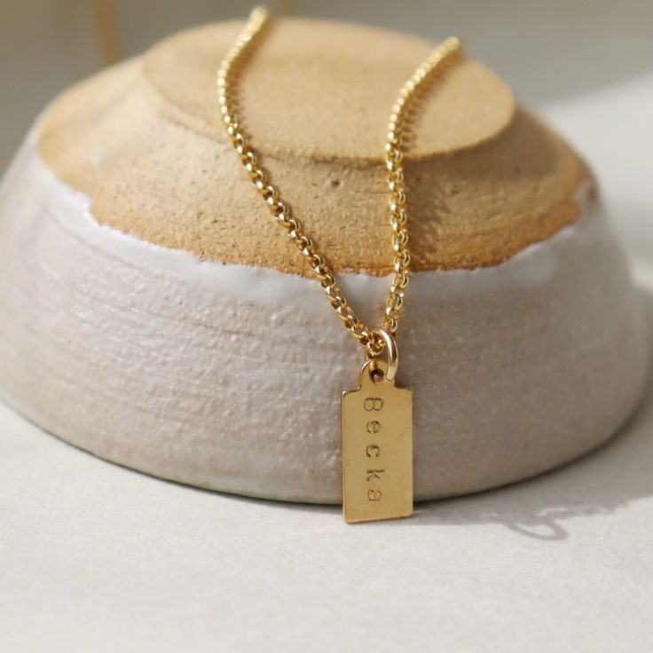 Our Mini Tag Personalized Necklace adds sentiment to any ensemble! Each necklace can feature up to 5 mini tags hand-stamped with up to 5 characters per tag. Strung around our tiny round link Dylan Chain, this customizable piece makes a sweet gift for your loved ones celebrating a special milestone in life! MEASUREMENTS Offered in 14k gold fill and sterling silver The tag measures 1/2" x 1/4" Choose from 1-5 tags Personalized Tags, Sweet Gifts, Stamping Up, Personalized Necklace, Tag Necklace, Hand Stamped, Gold Filled, Jewelry Design, Stamp