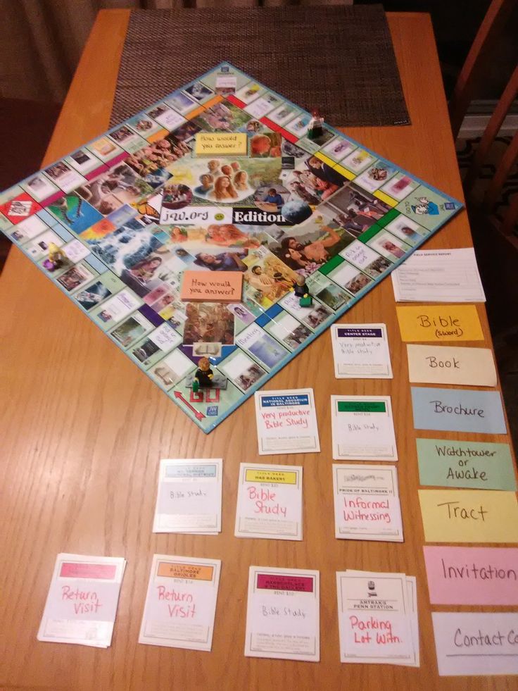 a board game sitting on top of a wooden table next to other cards and papers