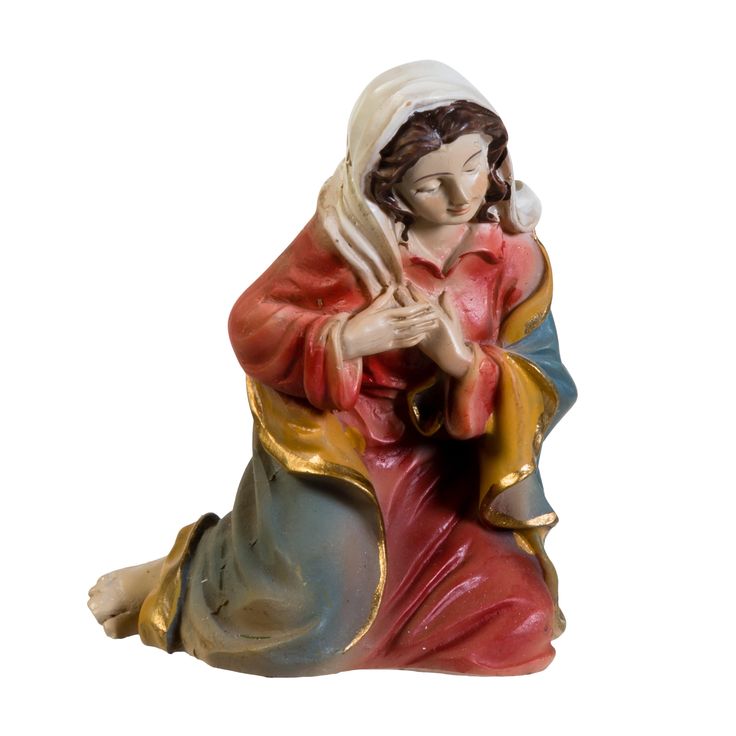 a figurine of a woman sitting on the ground with her hands folded in prayer