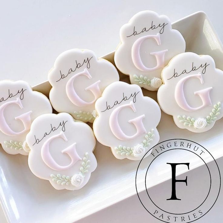 decorated cookies with the words baby, baby, and gg written in frosting