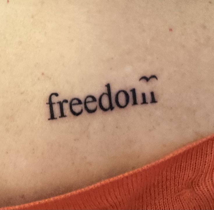 a woman's back with the word freedom written on it