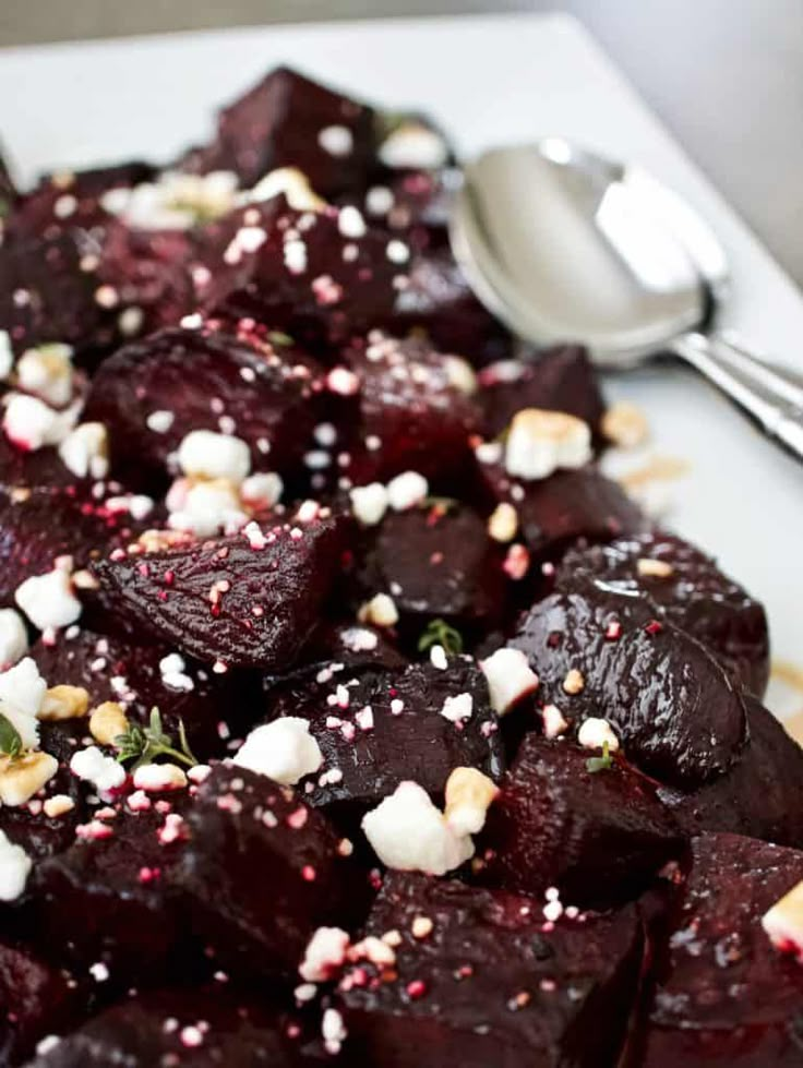 a white plate topped with beets and feta cheese