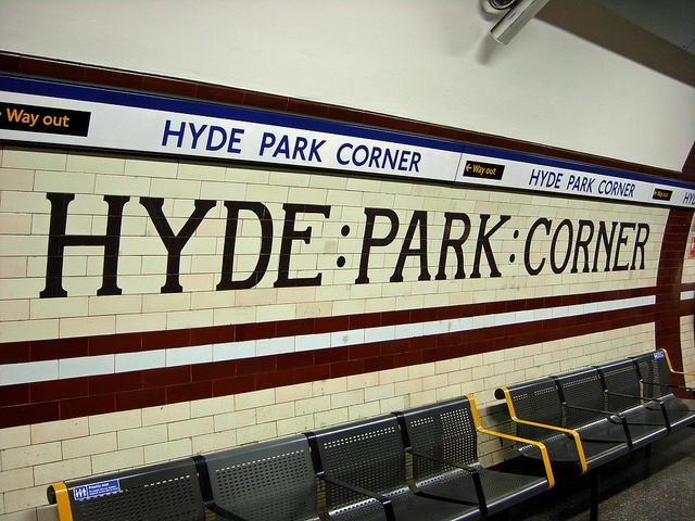 the sign for hyde park corner is displayed on the wall in the waiting area at the train station