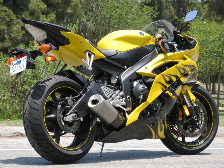 a yellow and black motorcycle parked on the street