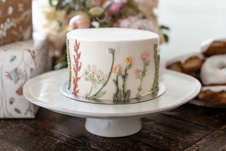 a white cake sitting on top of a wooden table