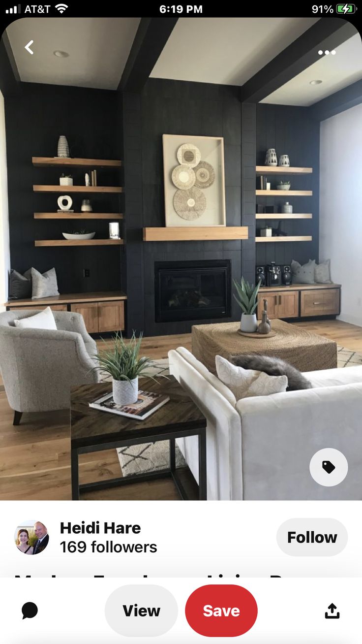 the living room is decorated in black and white with pops of color on the walls