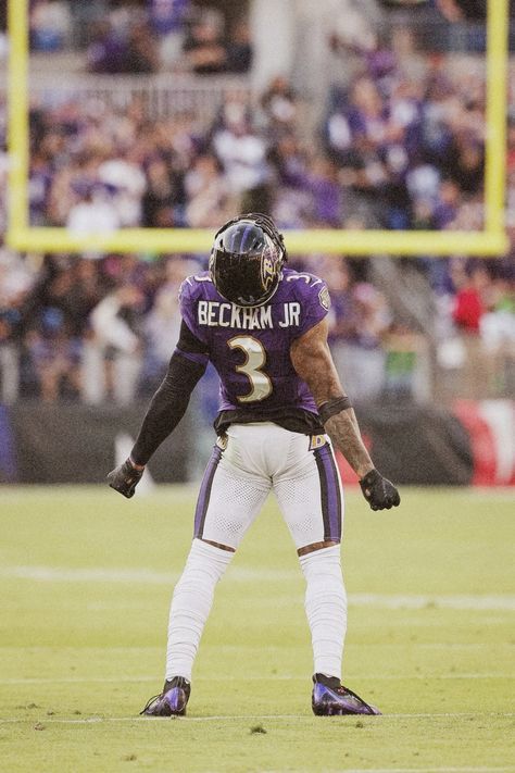 a football player standing on top of a field