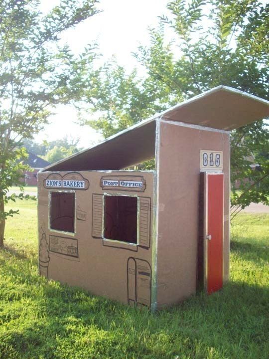 an outhouse in the middle of a grassy field with trees and grass around it