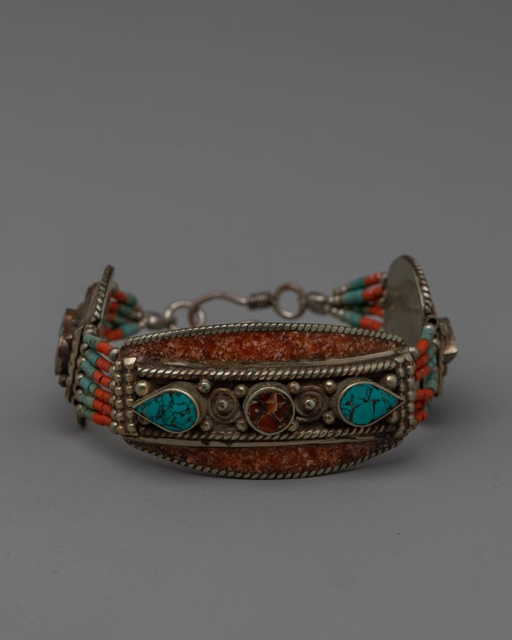 Handcrafted Tibetan Bracelet About The Bracelet: The exquisite combination of traditional creativity and cultural symbolism in this carved Tibetan bracelet is very stunning. This bracelet, which is crafted from white metal and embellished with artificial turquoise, lapis lazuli and coral stones, is a captivating piece of jewelry that perfectly embodies Tibetan handicraft. With dimensions of 18 cm in height and 2.5 cm in breadth and a weight of 0.032 kg, this jewelry piece is an ideal addition to Traditional Adjustable Beaded Bracelets With Natural Stones, Adjustable Traditional Bracelets For Rituals, Artisan Adjustable Jewelry For Festivals, Traditional Jewelry For Festivals, Bohemian Bracelets For Rituals, Bohemian Bracelets With Intricate Design For Festivals, Adjustable Traditional Jewelry For Rituals, Traditional Adjustable Jewelry For Rituals, Bohemian Festival Bracelets With Intricate Design