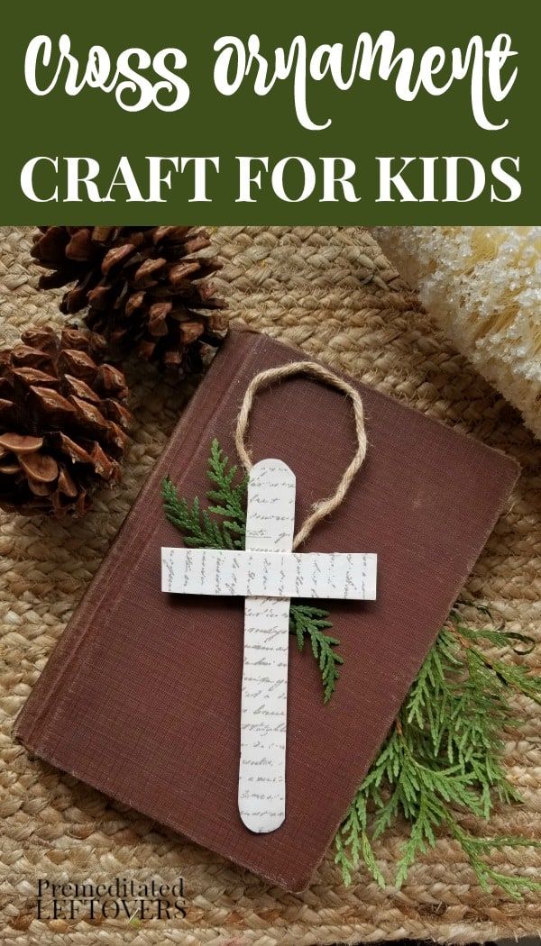 the cross ornament craft for kids with pine cones and twine on it