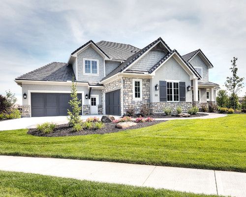 a large house with lots of windows and landscaping