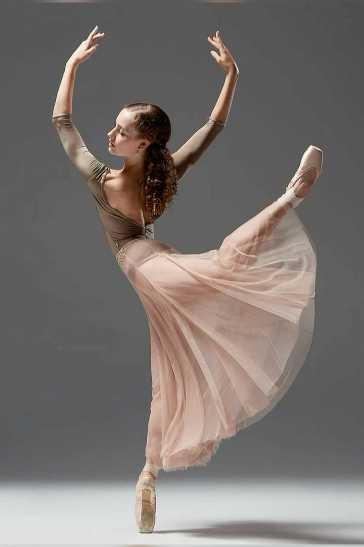 a woman in a pink dress is dancing with her legs spread out and arms outstretched