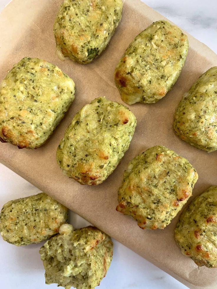 nine mini muffins are on a baking sheet with some green stuff in the middle