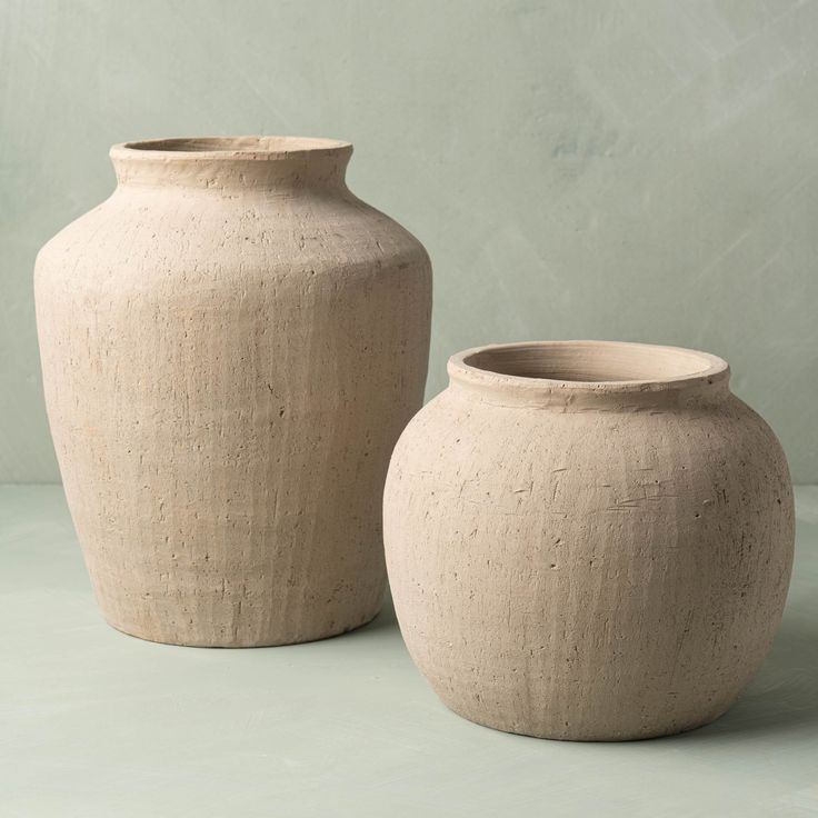 two vases sitting next to each other on a table