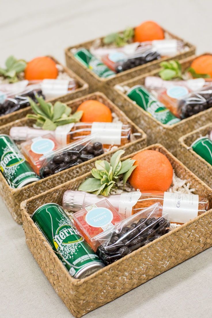 four baskets filled with assorted food items on top of a white tablecloth covered floor